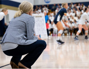gallery-4 Coach watching game with paper in hand