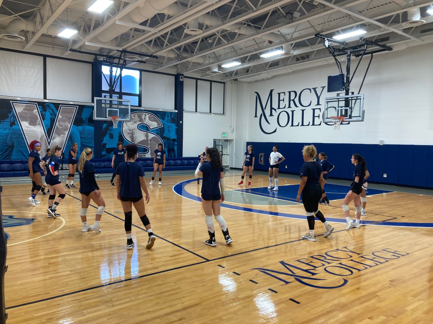 Team in gym training Mercy College women's volleyball team practice